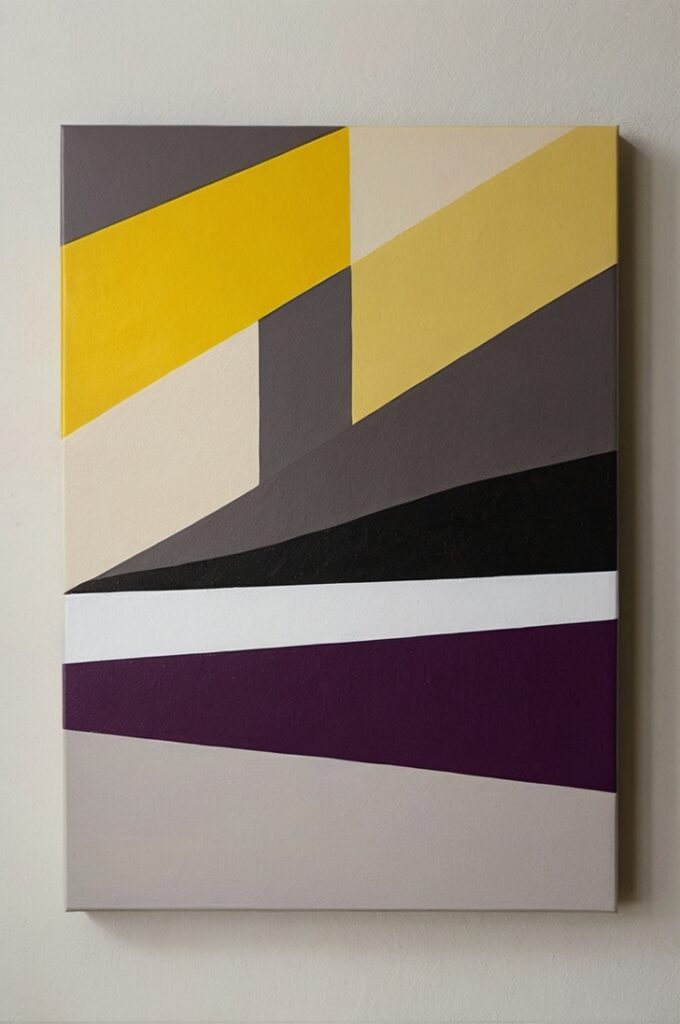 A modern, minimalist art piece created using painter’s tape and acrylic paint on canvas. Bold geometric patterns—triangles, diagonal lines, and intersecting shapes—are revealed through sharp, clean edges where the tape was removed. The color palette is contemporary and striking, featuring a mix of muted neutrals and bold accent tones like red, yellow and neon purple. The canvas is displayed on a clean, white wall in a bright, airy room, with natural light highlighting the texture of the paint. The overall aesthetic is sleek and artistic, blending DIY creativity with modern design.