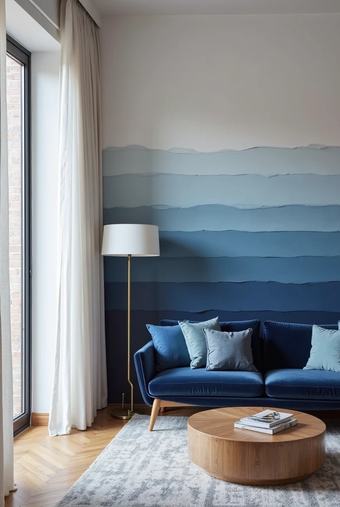 living room captured from a wide-angle, slightly elevated portrait viewpoint, showcasing a sophisticated space centered around a bold blue accent wall featuring layered monochromatic blues. The accent wall displays a thoughtfully curated design of horizontal color blocking with varying blue shades—from deep navy at the base to soft powder blue near the ceiling—creating subtle gradients and stripes that add rich dimension and visual depth without overwhelming the room.

The adjacent walls are painted a crisp white, enhancing the layered blue wall’s calming effect. A mid-century modern navy velvet sofa with tapered wooden legs faces the accent wall, adorned with cushions in different blue tones including steel, cobalt, and sky blue. In front, a round oak coffee table with a natural matte finish rests on a soft gray rug with subtle geometric patterns, grounding the seating area. To one side, a sleek floor lamp with a brushed brass finish and a white linen shade provides warm lighting. Large windows dressed with sheer white curtains fill the room with natural light, accentuating the blue layers’ texture and warmth. The overall ambiance is serene, inviting, and elegantly composed around the monochromatic blue accent wall.
